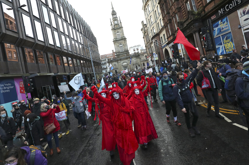 Climate activists from Extinction Rebellion march during a protest organized by the Cop26 Coalition in Glasgow, Scotland, Saturday, Nov. 6, 2021 which is the host city of the COP26 U.N. Climate Summit. The protest was taking place as leaders and activists from around the world were gathering in Scotland's biggest city for the U.N. climate summit, to lay out their vision for addressing the common challenge of global warming. (AP Photo/Scott Heppell)