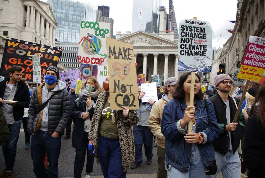Climate activists take part in a protest through the streets of London, Saturday, Nov. 6, 2021. Many people across the world are taking part in protests as the first week of the COP26, UN Climate Summit in Glasgow comes to an end. (AP Photo/David Cliff)