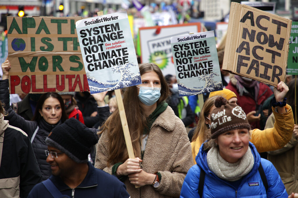Climate activists take part in a protest through the streets of London, Saturday, Nov. 6, 2021. Many people across the world are taking part in protests as the first week of the COP26, UN Climate Summit in Glasgow comes to an end. (AP Photo/David Cliff)