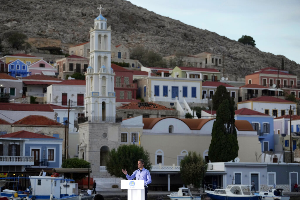 Greece's Prime Minister Kyriakos Mitsotakis delivers a speech during his visit at the tiny Aegean island of Chalki, southeastern Greece, Friday, Nov. 5, 2021. Mitsotakis inaugurates a green energy initiative on the island of Chalki, which is being billed as the country's first eco-island and as providing a blueprint for other islands to convert to green technology. The project involves the installation of a photovoltaic system for solar energy that covers the power requirements of the island's residents, and the donation of six electric vehicles for the police and coast guard, and one electric boat. (AP Photo/Thanassis Stavrakis)