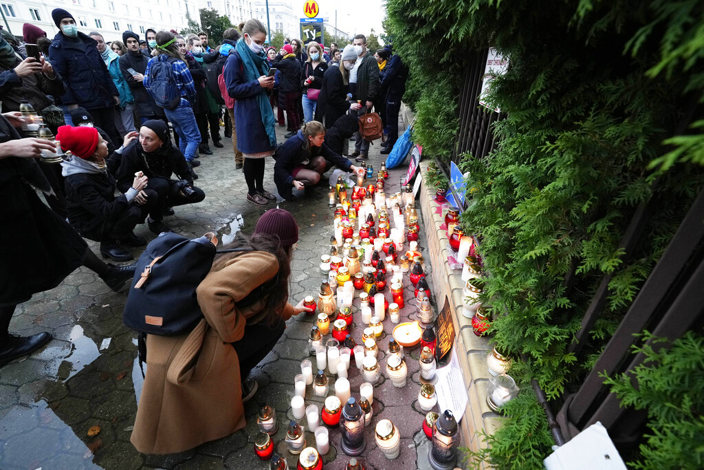 Warsaw residents place candles before the national Border Guards Headquarters in a sign of mourning for four migrants found dead over the weekend along the border between Poland and Belarus, Warsaw, Poland, on Monday, Sept. 20, 2021. European Union members Poland and Lithuania are facing increasing migrant pressures on their borders with Belarus, which are part of the bloc's eastern border and say it is a 
