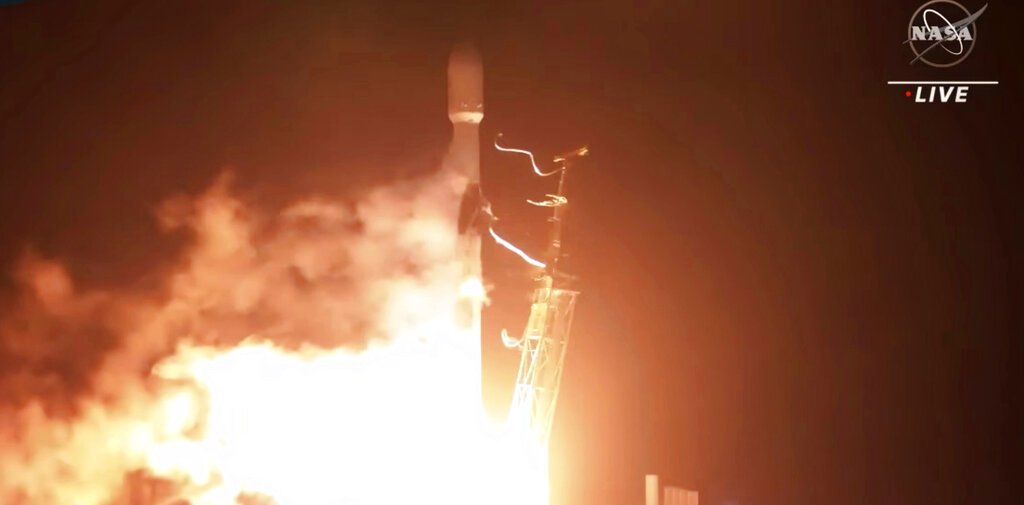 In this image taken from NASA video, the SpaceX Falcon 9 rocket with the Double Asteroid Redirection Test, or DART, spacecraft onboard, lifts off Tuesday, Nov. 23, 2021, from Vandenberg Space Force Base in Calif. NASA launched the spacecraft Tuesday night on a mission to smash into an asteroid and test whether it would be possible to knock a speeding space rock off course if one were to threaten Earth. (NASA via AP)