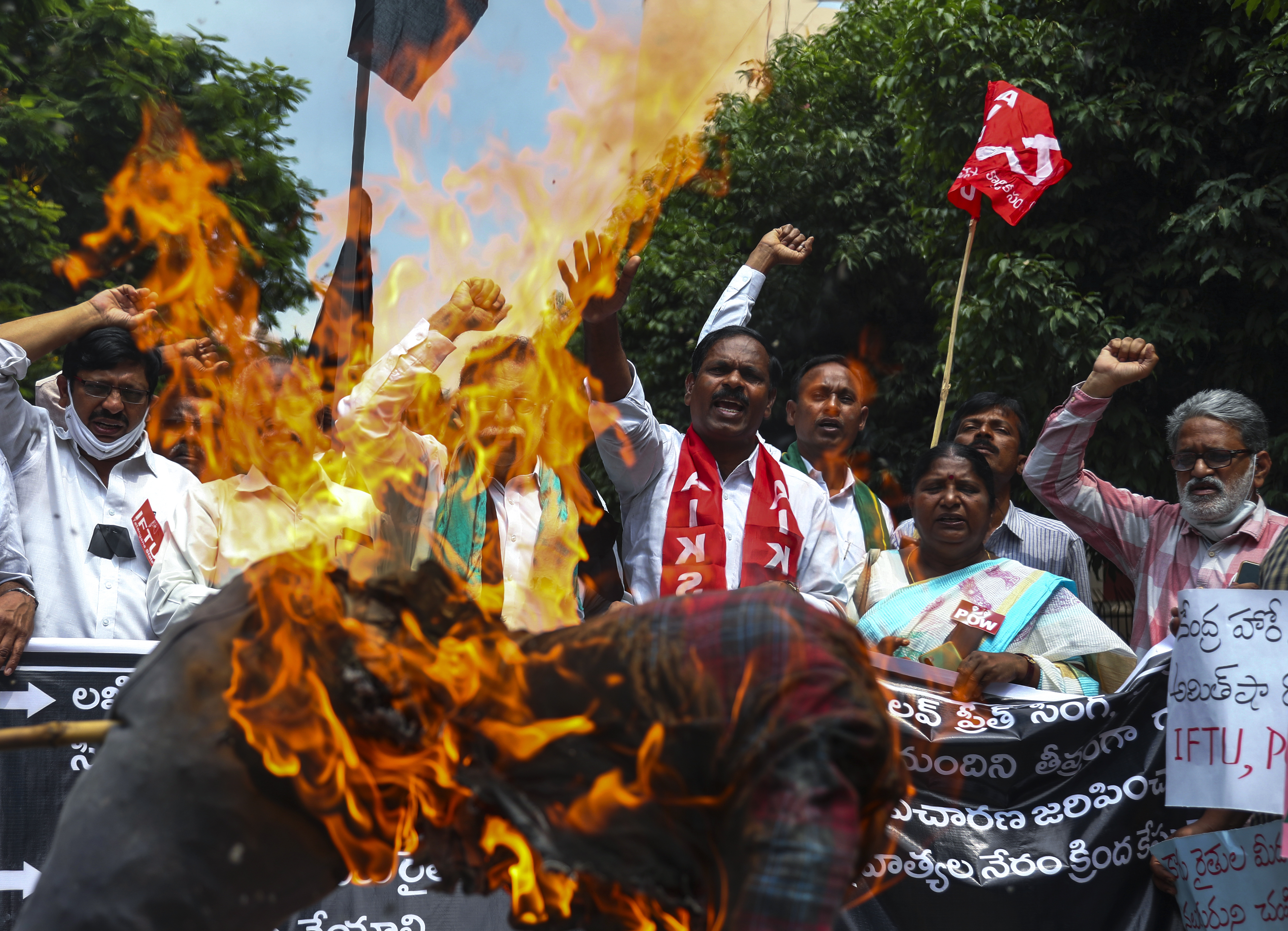 Indian farmers protesting against Sunday’s killing of four farmers in Uttar Pradesh state after being run over by a car owned by India's junior Home Minister Ajay Mishra burn an effigy of the federal government in Hyderabad, India, Monday, Oct. 4, 2021. Indian authorities on Monday suspended Internet services and barred political leaders from entering a northern town to calm tensions after eight people were killed in a deadly escalation of a year-long demonstration against contentious agriculture laws. (AP Photo/Mahesh Kumar A.)