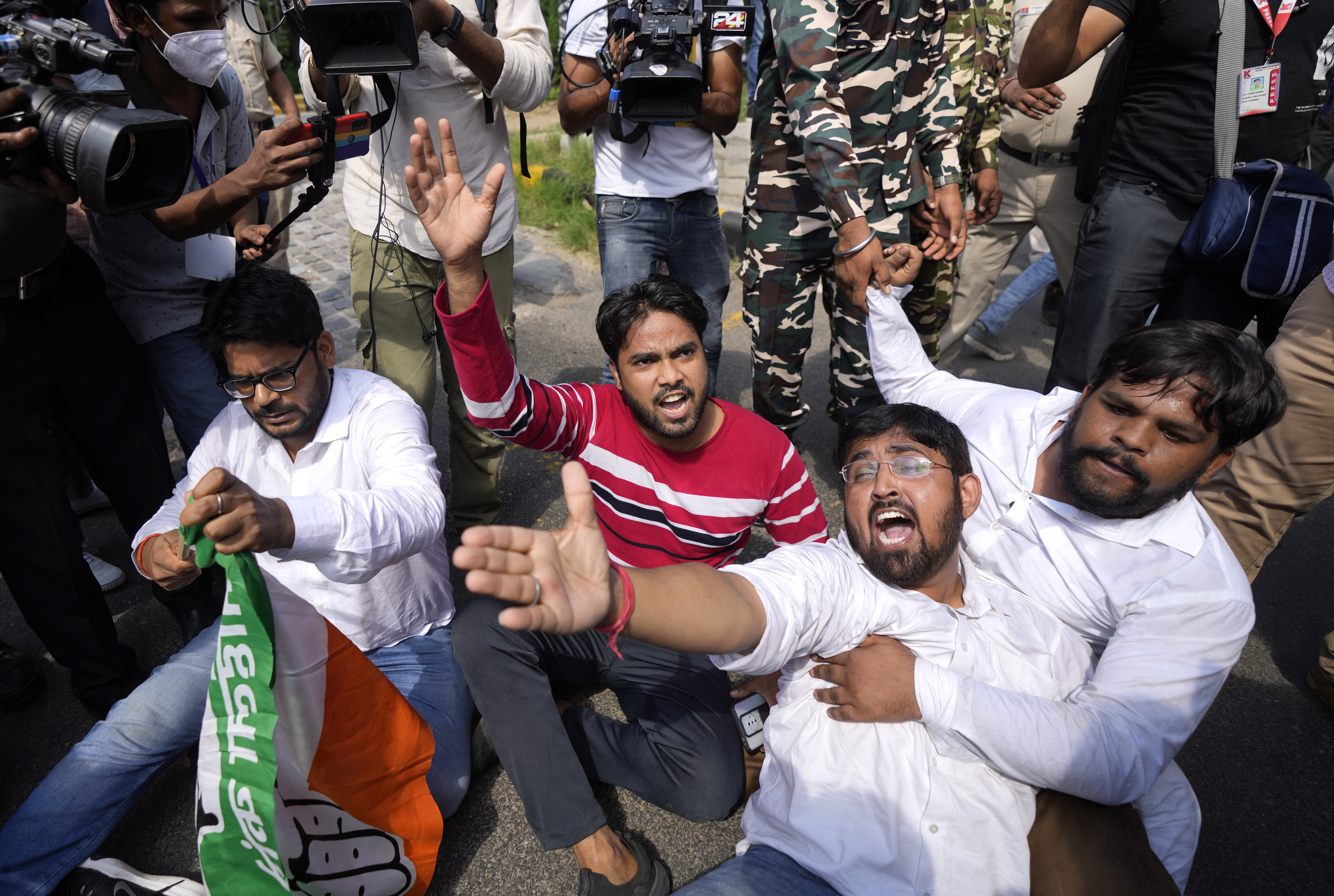 Activists of Congress party's youth wing protesting against Sunday's killing of four farmers in Uttar Pradesh state after being run over by a car owned by India's junior home minister shout slogans in New Delhi, India, Monday, Oct. 4, 2021. Indian authorities suspended internet services and barred political leaders from entering a northern town Monday to calm tensions after nine people were killed in a deadly escalation of a yearlong demonstration against contentious agriculture laws. (AP Photo/Manish Swarup)