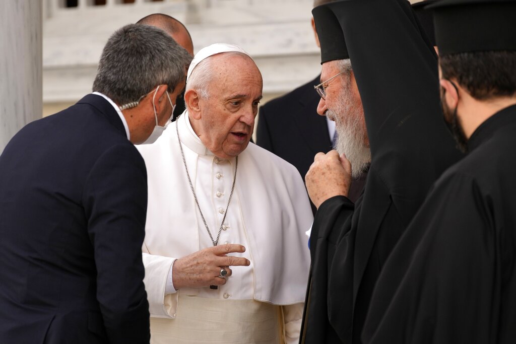CORRECT NAME OF THE PHOTOGRAPHER - Pope Francis, center, speaks with Archbishop Chrisostomos, right, after a ceremony at the Apostolos Barnavas Orthodox Cathedral in Nicosia, Cyprus, Friday, Dec. 3, 2021. Francis is on a five-day trip to Cyprus and Greece by drawing attention once again to his call for Europe to welcome migrants. (AP Photo/Petros Karadjias)