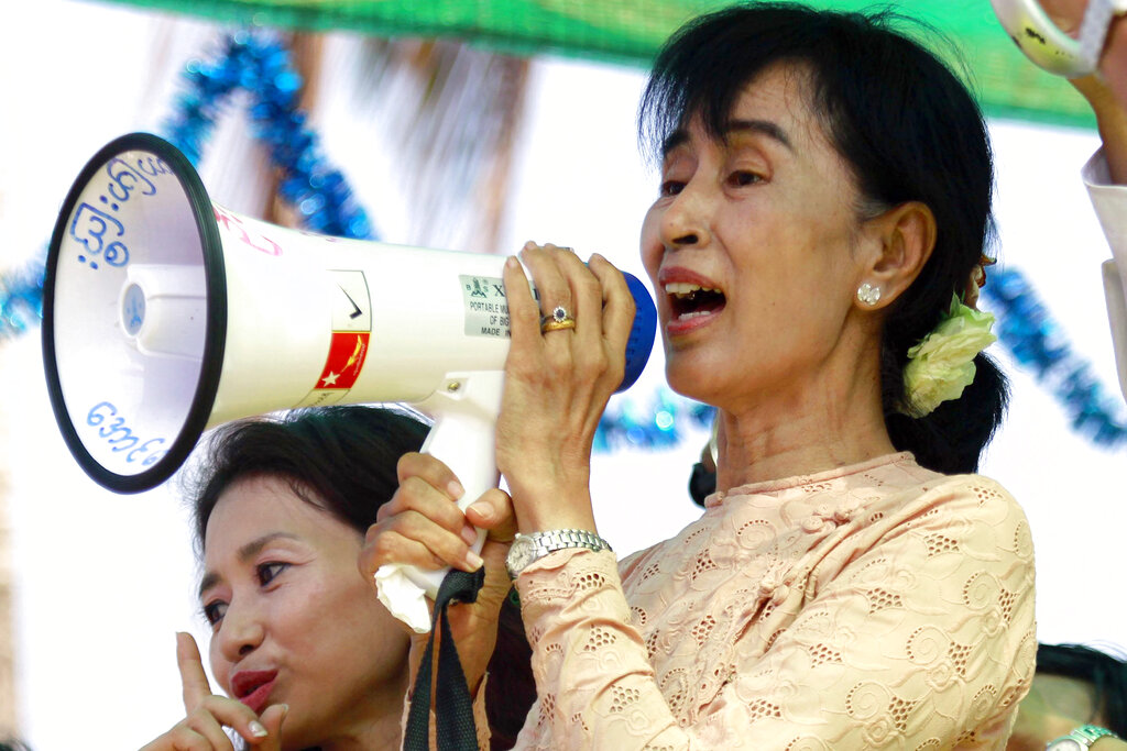 FILE - Myanmar pro-democracy icon Aung San Suu Kyi speaks to her supporters during her election campaign in Myeik, Myanmar on March 24, 2012.  (AP Photo/Khin Maung Win, File)