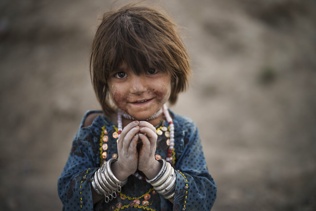 Laila poses for a photo on Sept. 27, 2021, as she plays in a poor neighborhood in Kabul, Afghanistan, where hundreds of internally displaced people from the eastern part of the country have been living for years. (AP Photo/Felipe Dana)