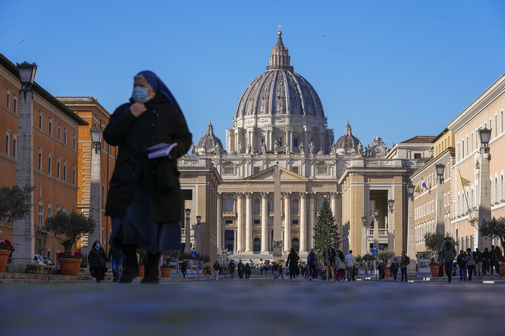 A nun walks past St. Peter's Square and Basilica, at the Vatican, Friday, Dec. 17, 2021. Pope Francis is celebrating his 85th birthday Friday, a milestone made even more remarkable given the coronavirus pandemic, his summertime intestinal surgery and the weight of history: His predecessor retired at this age and the last pope to have lived any longer was Leo XIII over a century ago. (AP Photo/Andrew Medichini)