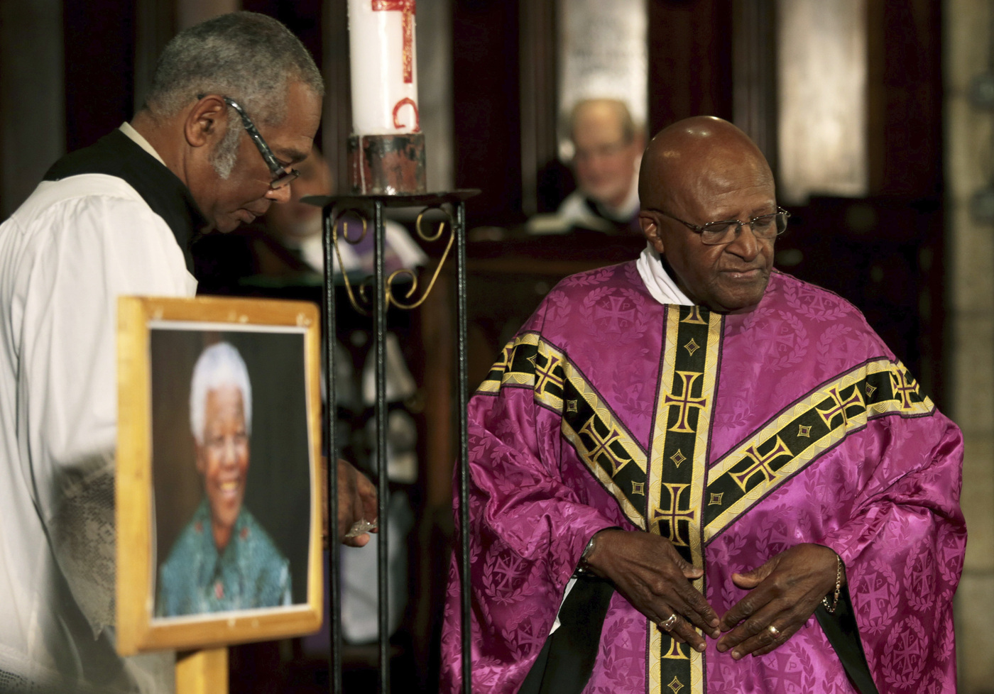 FILE - Anglican Archbishop Emeritus Desmond Tutu, right, leads a prayer service in memory of former South African president Nelson Mandela, at St George's Cathedral in Cape Town, South Africa, Friday, Dec. 6, 2013. Tutu, South Africa’s Nobel Peace Prize-winning activist for racial justice and LGBT rights and retired Anglican Archbishop of Cape Town, has died, South African President Cyril Ramaphosa announced Sunday Dec. 26, 2021. He was 90. (AP Photo, File)