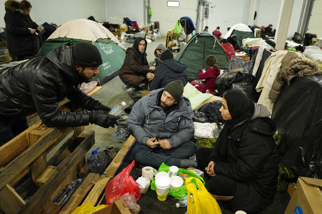 Migrants settle in the logistics center at the checkpoint logistics center 