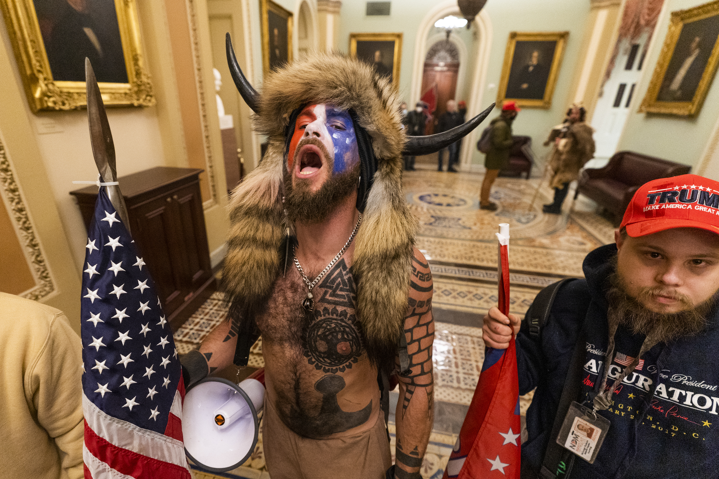 A supporter of President Donald Trump chants outside the Senate Chamber inside the Capitol, Wednesday, Jan. 6, 2021 in Washington. (AP Photo/Manuel Balce Ceneta)
