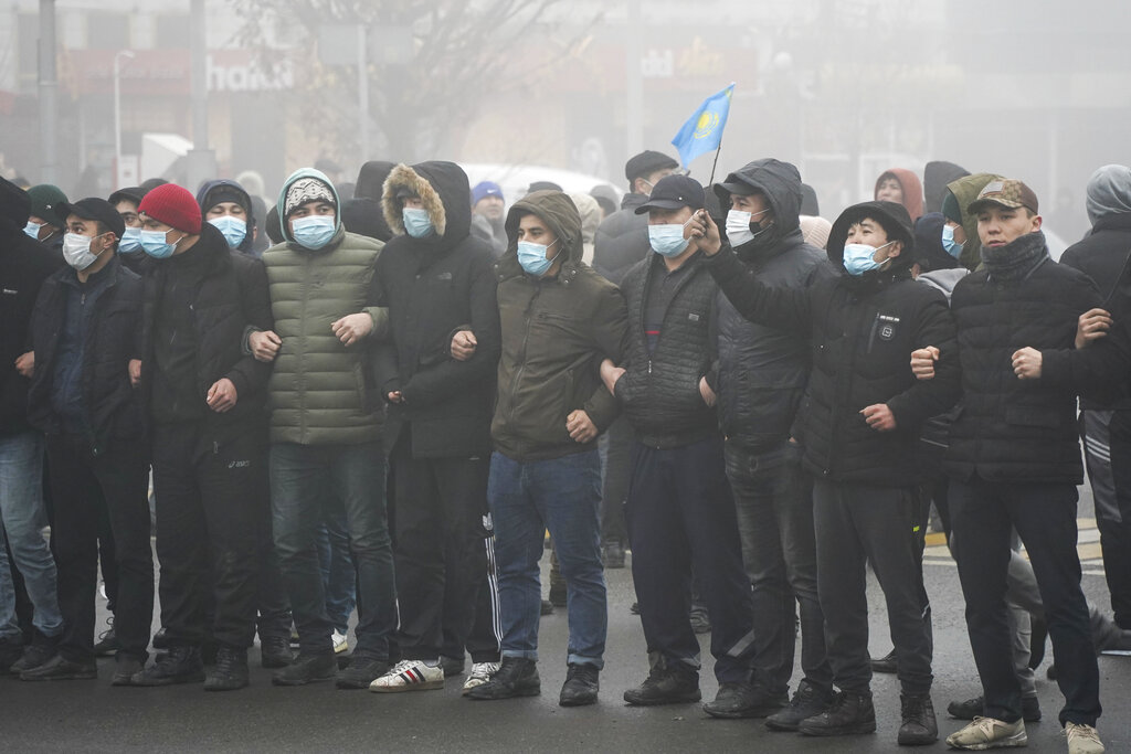 Demonstrators stand in front of police line during a protest in Almaty, Kazakhstan, Wednesday, Jan. 5, 2022. Demonstrators denouncing the doubling of prices for liquefied gas have clashed with police in Kazakhstan's largest city and held protests in about a dozen other cities in the country. (AP Photo/Vladimir Tretyakov)