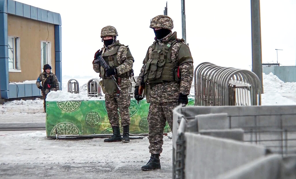 In this image taken from footage provided by the RU-RTR Russian television, Kazakhstan's soldiers guard a check point in Kazakhstan, Friday, Jan. 7, 2022. The President of Kazakhstan said Friday he authorized law enforcement to open fire on 