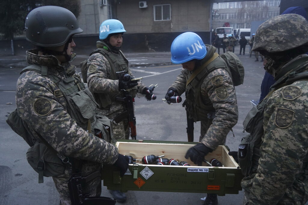 Kazakhstan soldiers select flash grenades as they prepare to stop protesters, in Almaty, Kazakhstan, Thursday, Jan. 6, 2022. Kazakhstan's president authorized security forces on Friday to shoot to kill those participating in unrest, opening the door for a dramatic escalation in a crackdown on anti-government protests that have turned violent. The Central Asian nation this week experienced its worst street protests since gaining independence from the Soviet Union three decades ago, and dozens have been killed in the tumult.(Vladimir Tretyakov/NUR.KZ via AP)