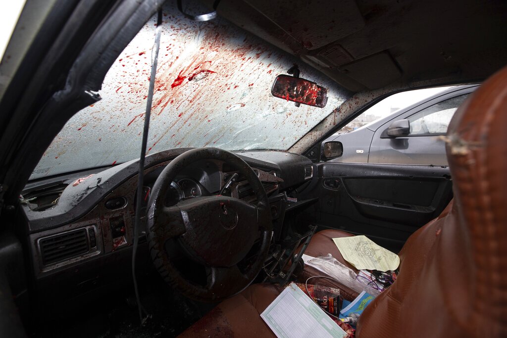 A car windshield is stained with blood following clashes in the central square blocked by Kazakhstan troops and police in Almaty, Kazakhstan, Monday, Jan. 10, 2022. The National Security Committee, Kazakhstan's counterintelligence and anti-terrorism agency, said that the situation in the country has 