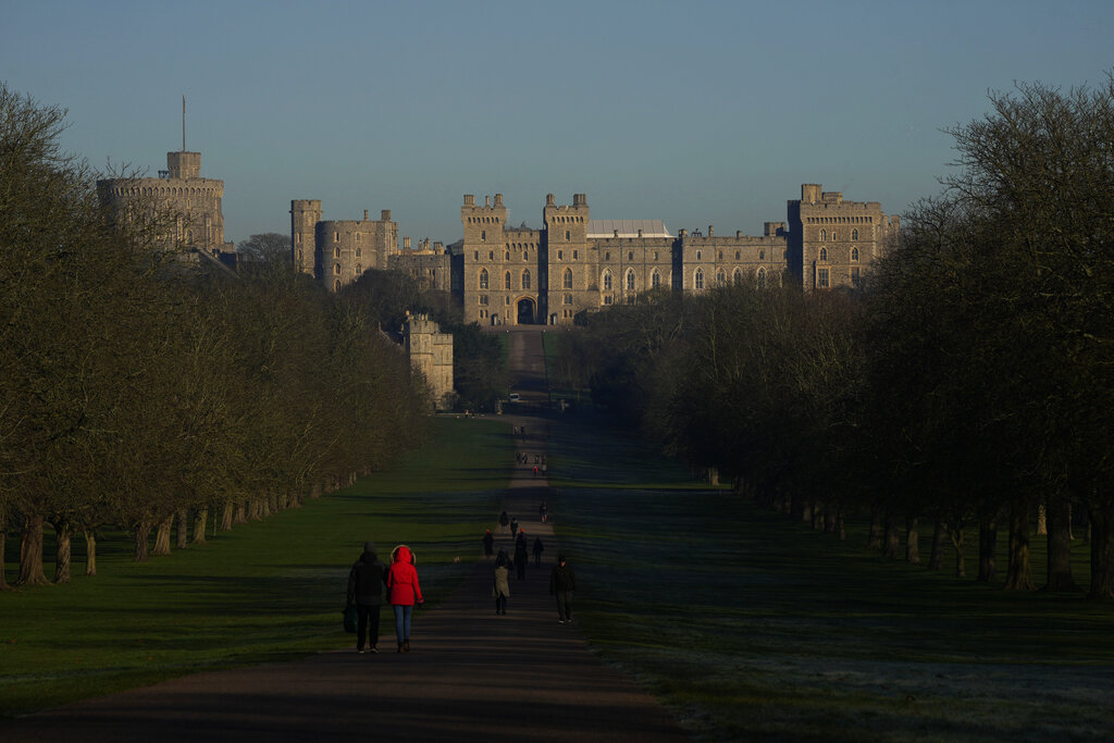 People walk along the Long Walk leading to Windsor Castle, in Windsor, England, where Prince Andrew's residence is nearby in the grounds of Windsor Great Park, Thursday, Jan. 13, 2022. A judge has — for now — refused to dismiss a lawsuit against Britain's Prince Andrew by an American woman who says he sexually abused her when she was 17. Stressing Wednesday that he wasn't ruling on the truth of the allegations, U.S. District Judge Lewis A. Kaplan rejected an argument by Andrew's lawyers that Virginia Giuffre's lawsuit should be thrown out at an early stage because of an old legal settlement she had with Jeffrey Epstein, the financier she claims set up sexual encounters with the prince. (AP Photo/Matt Dunham)