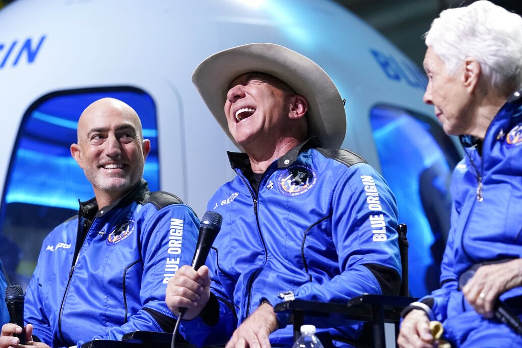Mark Bezos, left, Jeff Bezos, center, founder of Amazon and space tourism company Blue Origin, and Wally Funk, right, make comments during a post launch news briefing from its spaceport near Van Horn, Texas, Tuesday, July 20, 2021. (AP Photo/Tony Gutierrez)