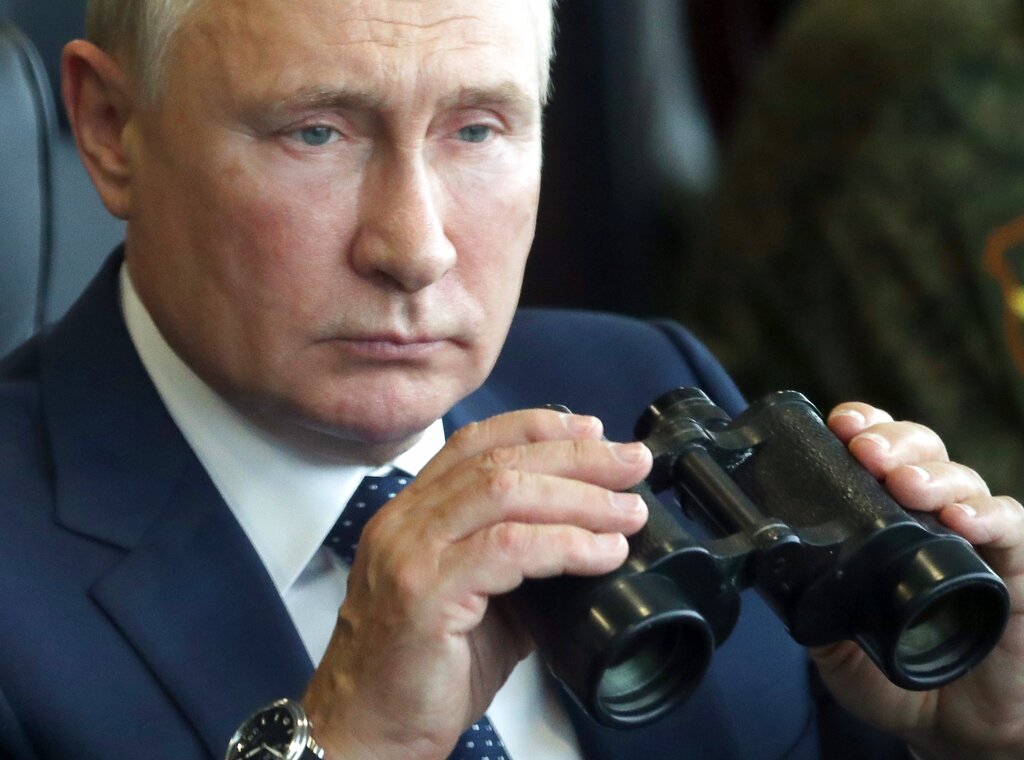FILE - Russian President Vladimir Putin holds binoculars as he watches the joint strategic exercise of the armed forces of the Russian Federation and the Republic of Belarus Zapad-2021 at the Mulino training ground in the Nizhny Novgorod region, Russia, Sept. 13, 2021. Putin has described NATO membership for Ukraine and other ex-Soviet nations and the alliance weapons deployments there as a red line for Moscow, warning that he would order unspecified 