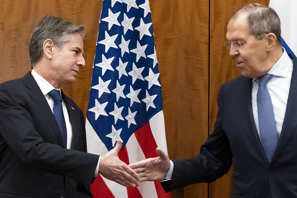 FILE - Secretary of State Antony Blinken, left, greets Russian Foreign Minister Sergey Lavrov before their meeting, Friday, Jan. 21, 2022, in Geneva, Switzerland. With tens of thousands of Russian troops positioned near Ukraine, the Kremlin has kept the U.S. and its allies guessing about its next moves in the worst security crisis to emerge between Moscow and the West since the Cold War. (AP Photo/Alex Brandon, Pool, File)