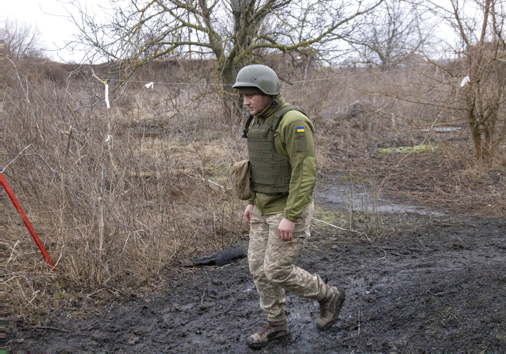 A Ukrainian soldier walks on the line of separation from pro-Russian rebels, Mariupol, Donetsk region, Ukraine, Friday, Jan. 21, 2022. Blinken said the U.S. would be open to a meeting between Putin and U.S. President Joe Biden, if it would be “useful and productive.” The two have met once in person in Geneva and have had several virtual conversations on Ukraine that have proven largely inconclusive. Washington and its allies have repeatedly promised consequences such as biting economic sanctions against Russia — though not military action — if it invades. (AP Photo/Andriy Dubchak)