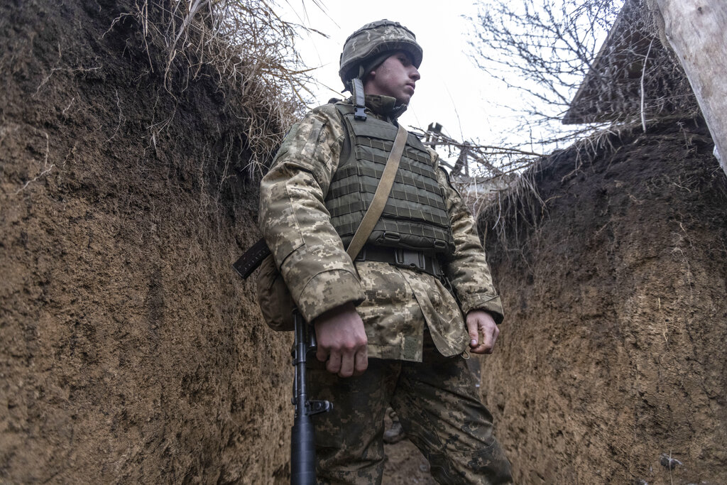 A Ukrainian soldier stands in the trench on the line of separation from pro-Russian rebels, Mariupol, Donetsk region, Ukraine, Friday, Jan. 21, 2022. Blinken said the U.S. would be open to a meeting between Putin and U.S. President Joe Biden, if it would be “useful and productive.” The two have met once in person in Geneva and have had several virtual conversations on Ukraine that have proven largely inconclusive. Washington and its allies have repeatedly promised consequences such as biting economic sanctions against Russia — though not military action — if it invades. (AP Photo/Andriy Dubchak)
