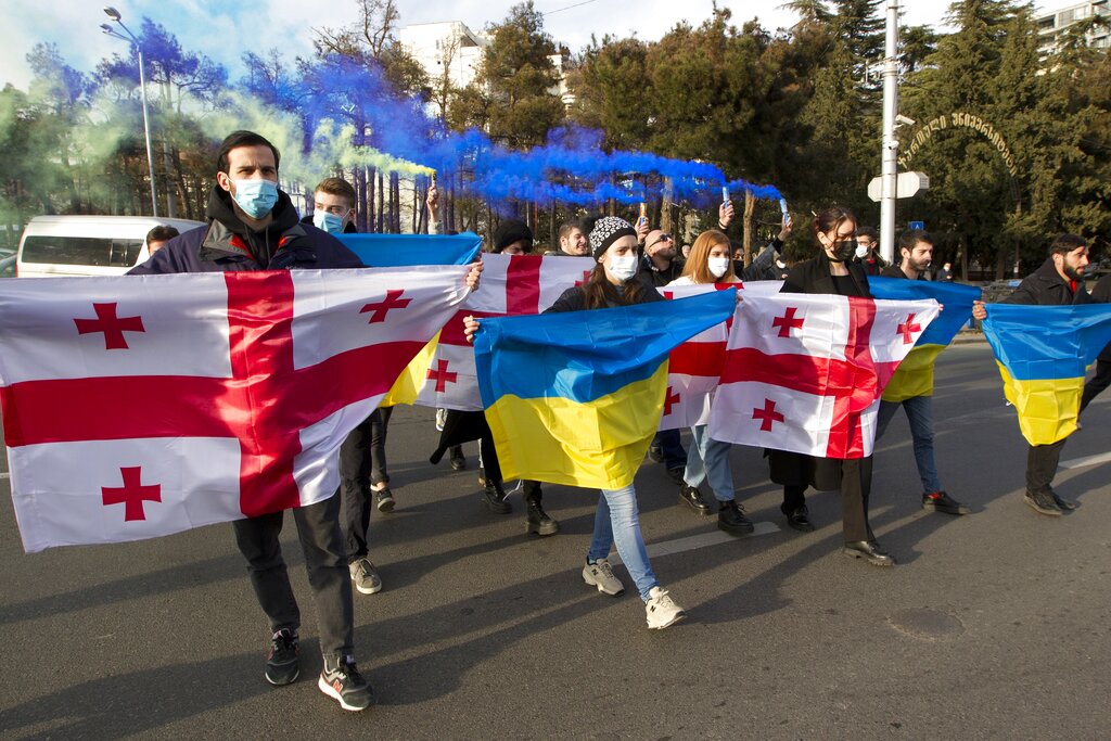 Georgian activists hold Ukrainian and Georgian national flags as they gather in support of Ukraine in front of the Ukrainian Embassy in Tbilisi, Georgia, Sunday, Jan. 23, 2022. The British government on Saturday accused Russia of seeking to replace Ukraine's government with a pro-Moscow administration, and said former Ukrainian lawmaker Yevheniy Murayev is being considered as a potential candidate. (AP Photo/Shakh Aivazov)