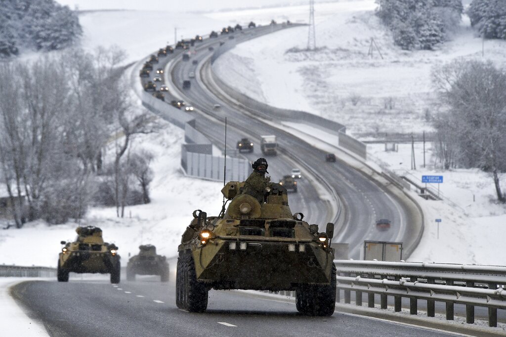 FILE - A convoy of Russian armored vehicles moves along a highway in Crimea, Tuesday, Jan. 18, 2022. Russia has concentrated an estimated 100,000 troops with tanks and other heavy weapons near Ukraine in what the West fears could be a prelude to an invasion. Germany's refusal to join other NATO members in supplying Ukraine with weapons has frustrated allies and prompted some to question Berlin's resolve in standing up to Russia. (AP Photo, File)
