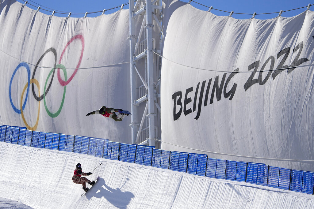 A snowboarder catches air while training on the half pipe ahead of the 2022 Winter Olympics, Thursday, Jan. 27, 2022, in Zhangjiakou, China. (AP Photo/Jae C. Hong)