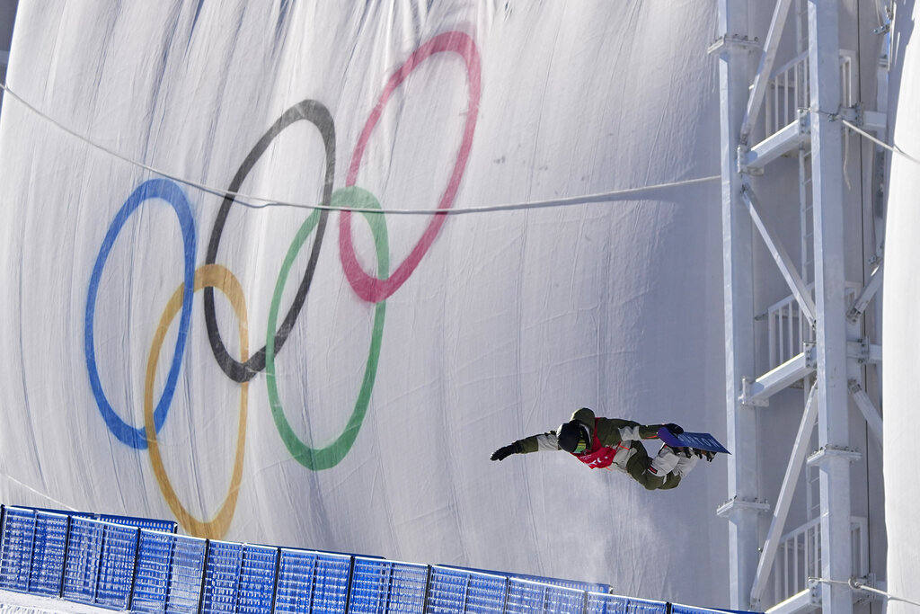 A snowboarder catches air while training on the half pipe ahead of the 2022 Winter Olympics, Thursday, Jan. 27, 2022, in Zhangjiakou, China. (AP Photo/Jae C. Hong)