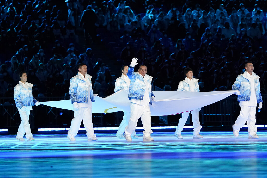 The Olympic flag is carried into the stadium during the opening ceremony of the 2022 Winter Olympics, Friday, Feb. 4, 2022, in Beijing. (AP Photo/Jae C. Hong)