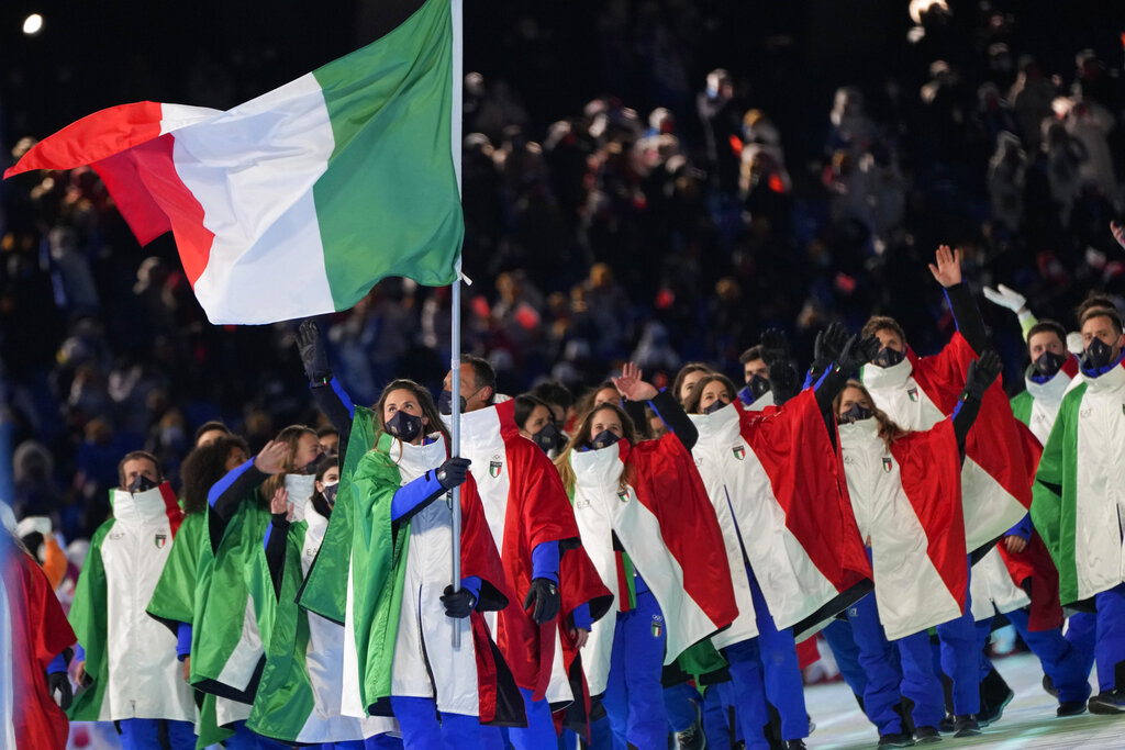 Michela Moioli, of Italy, carries her national flag during the opening ceremony of the 2022 Winter Olympics, Friday, Feb. 4, 2022, in Beijing. (AP Photo/Natacha Pisarenko)