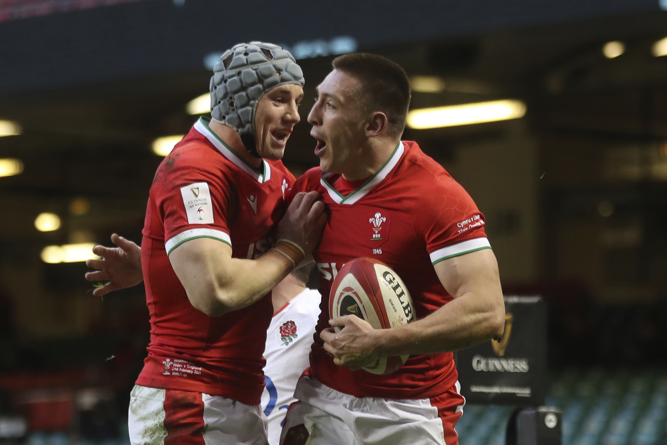 FILE -Wales' Josh Adams, right celebrates after scoring the opening try with teammate Wales' Jonathan Davies during the Six Nations rugby union match between Wales and England at the Millennium stadium in Cardiff, Wales, Saturday, Feb. 27, 2021. Ahead of the upcoming Six Nations, Four teams stand out. England is the highest ranked, Ireland is on an eight-test winning run, France is improving quicker than any test nation ahead of hosting next year’s Rugby World Cup, and Wales has pedigree with four titles in the last 10 years. (David Davies/Pool Via AP, File )