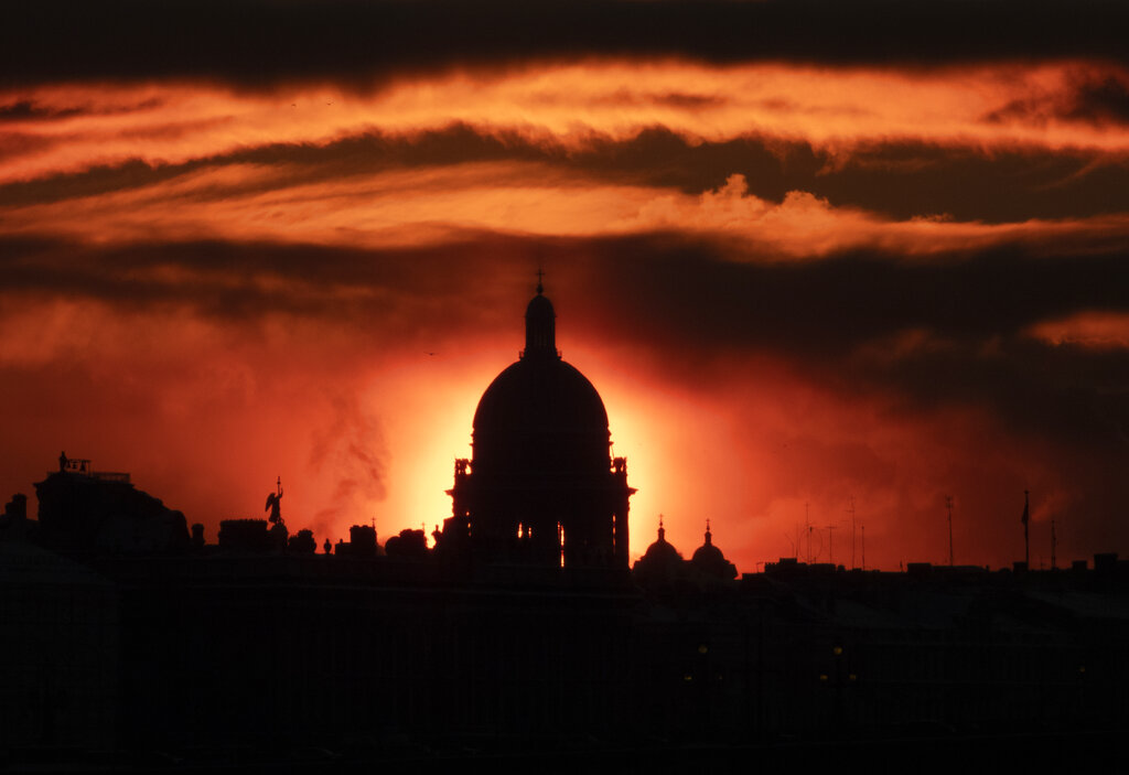 One of the city's landmarks St. Isaac's Cathedral is silhouetted as the sun sets in St. Petersburg, Russia, Tuesday, Jan. 11, 2022. (AP Photo/Dmitri Lovetsky)