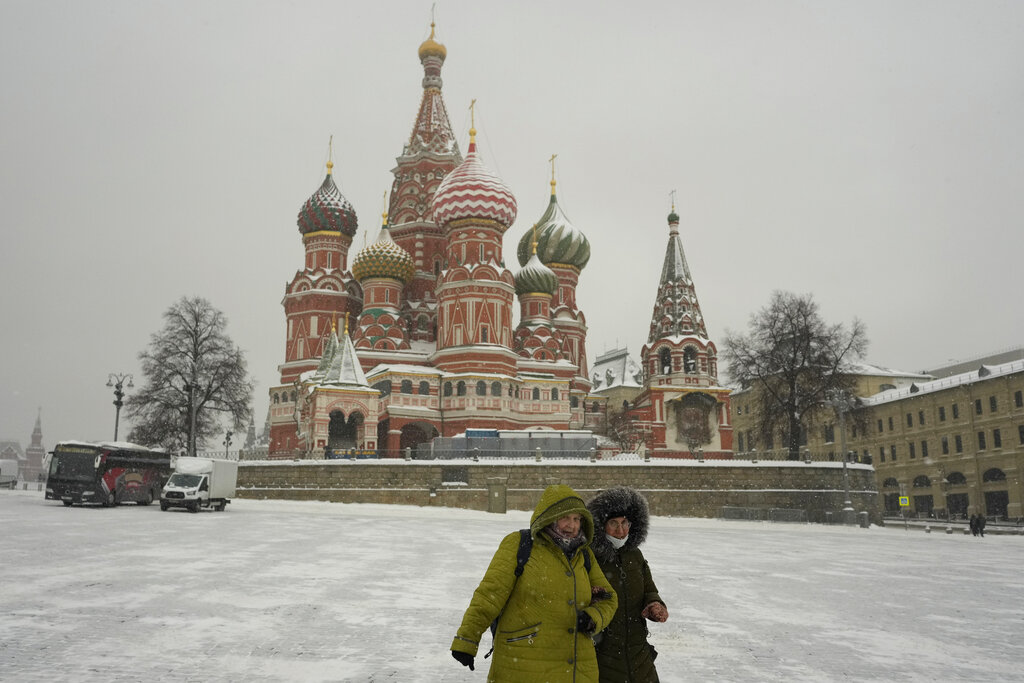 Women walk past the St. Basil's Cathedral, in Moscow, Russia, Monday, Feb. 7, 2022. (AP Photo/Thibault Camus)