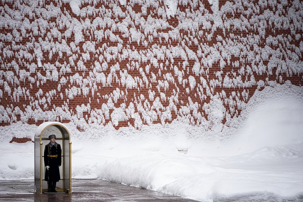 A soldier of the Kremlin guard stands at the Tomb of Unknown Soldier at the Kremlin Wall after a snowfall in Moscow, Russia, Monday, Feb. 7, 2022. (AP Photo/Alexander Zemlianichenko)