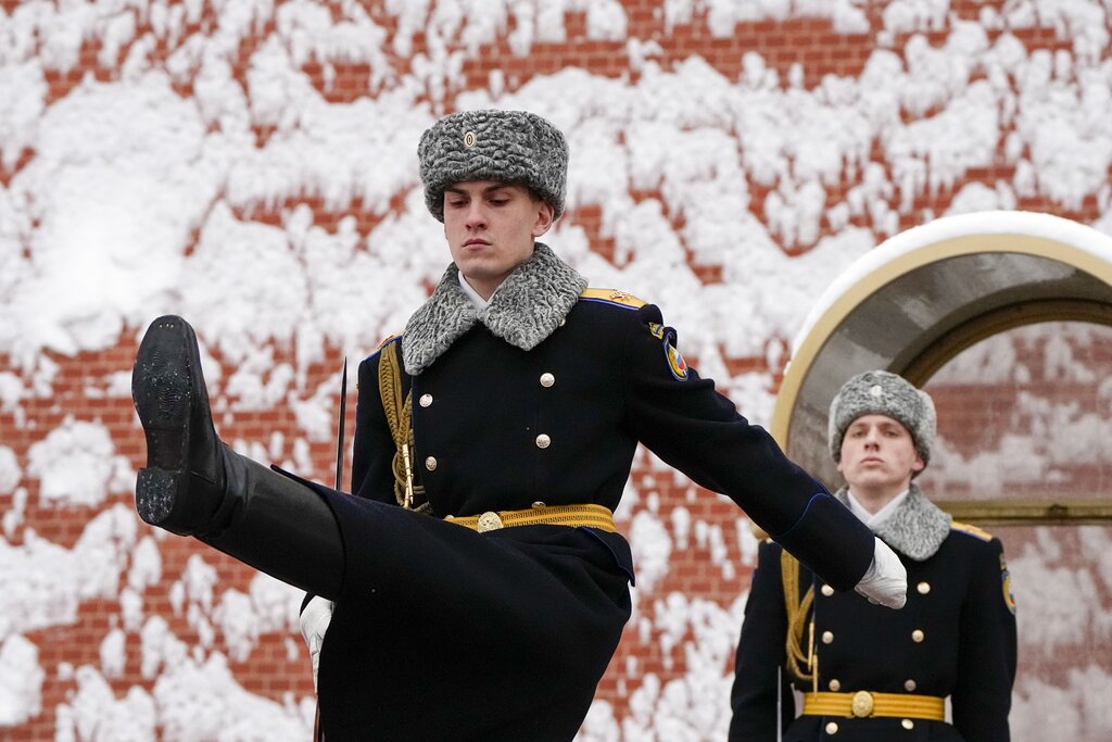 The Kremlin guards change at the Tomb of Unknown Soldier at the Kremlin Wall after a snowfall in Moscow, Russia, Monday, Feb. 7, 2022. (AP Photo/Alexander Zemlianichenko)