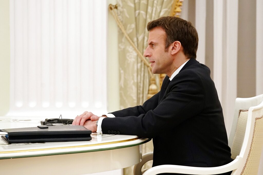 French President Emmanuel Macron speaks to Russian President Vladimir Putin during their meeting in the Kremlin in Moscow, Russia, Monday, Feb. 7, 2022. Macron traveled to Moscow in a bid to help defuse tensions amid a Russian troop buildup near Ukraine that fueled fears of an invasion. (Sputnik, Kremlin Pool Photo via AP)