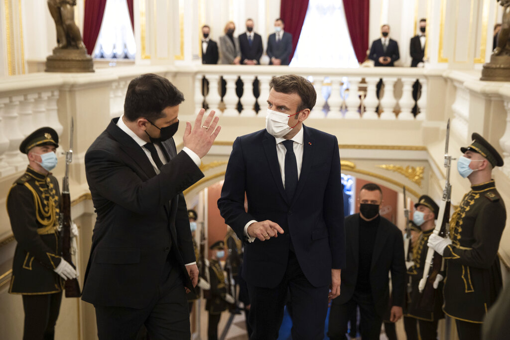 In this handout photo provided by the Ukrainian Presidential Press Office, Ukrainian President Volodymyr Zelenskyy, left, gestures while speaking to French President Emmanuel Macron during their meeting in Kyiv, Ukraine on Tuesday, Feb. 8, 2022. Diplomatic efforts to defuse the tensions around Ukraine continued on Tuesday with French President Emmanuel Macron in Kyiv the day after hours of talks with the Russian leader in Moscow yielded no apparent breakthroughs. (Ukrainian Presidential Press Office via AP)
