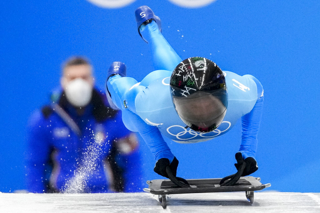 Amedeo Bagnis, of Italy, starts slides during men's skeleton run 3 at the 2022 Winter Olympics, Friday, Feb. 11, 2022, in the Yanqing district of Beijing. (AP Photo/Mark Schiefelbein)