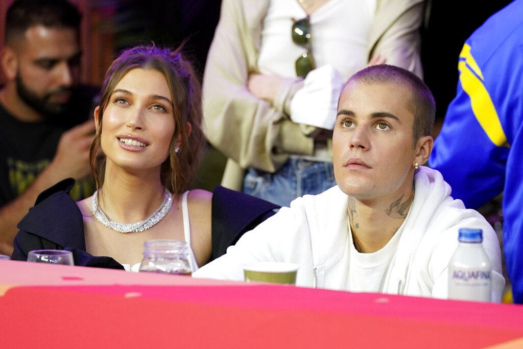 Justin Bieber, right, and his wife, Hailey, watch during halftime of the NFL Super Bowl 56 football game between the Los Angeles Rams and the Cincinnati Bengals Sunday, Feb. 13, 2022, in Inglewood, Calif. (AP Photo/Lynne Sladky)