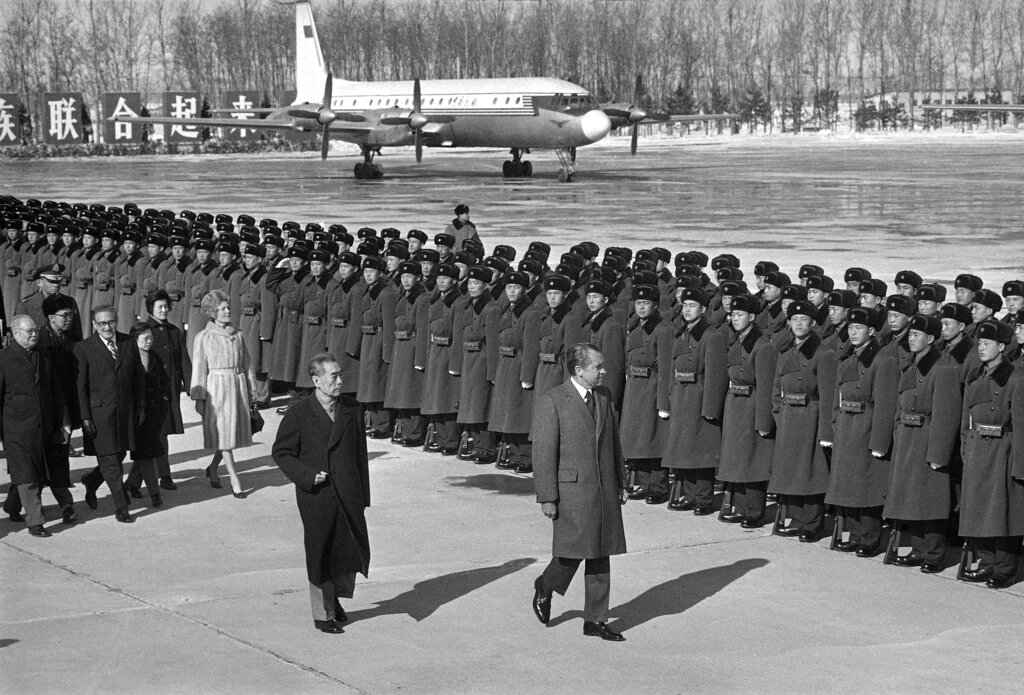 FILE - Then U.S. President Richard Nixon and then Chinese Premier Zhou Enlai review Chinese troops at Nixon's departure from Beijing to Hangchow to continue his China visit, Feb. 26, 1972. First lady Pat Nixon and National Securty adviser Henry Kissinger are seen walking behind Nixon and Zhou. At the height of the Cold War, U.S. President Richard Nixon flew into communist China's center of power for a visit that over time would transform U.S.-China relations and China's position in the world in ways that were unimaginable at the time. (AP Photo, File)