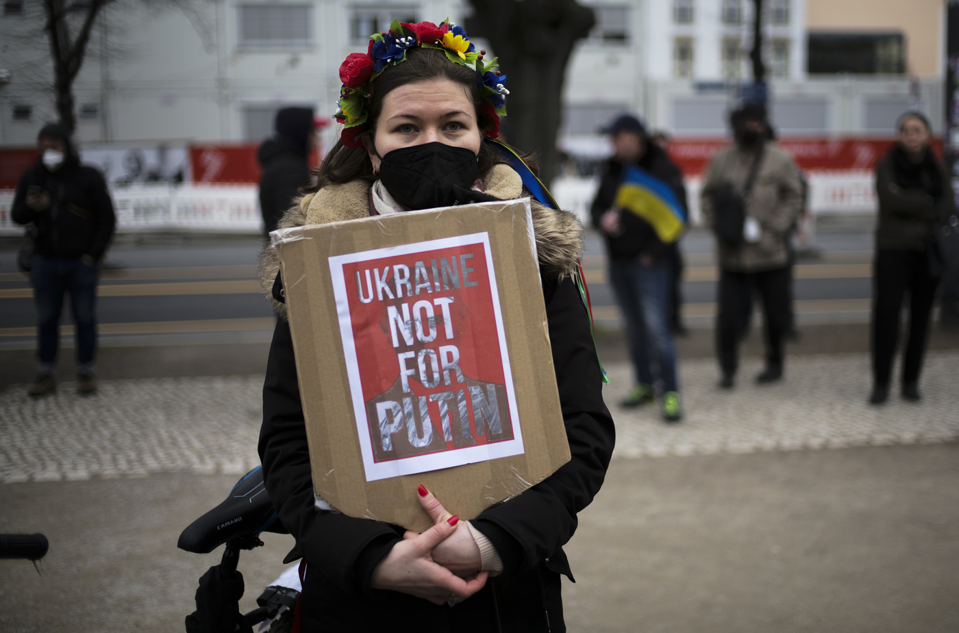 A woman attends a protest against the Russian invasion in the Ukraine in front of the Russian embassy in Berlin, Germany, Friday, Feb. 25, 2022. (AP Photo/Markus Schreiber)