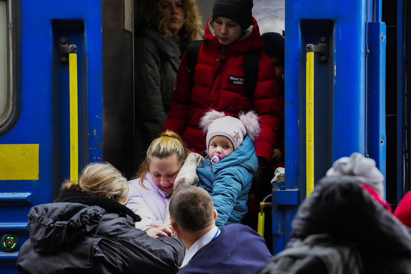 People fleeing the conflict from neighboring Ukraine arrive to Przemysl train station in Przemysl, Poland, on Friday, Feb. 25, 2022. (AP Photo/Petr David Josek)