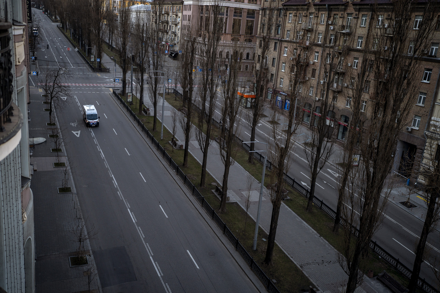 An emergency vehicle drives on an empty street during a curfew in the central of Kyiv, Ukraine, Sunday, Feb. 27, 2022. A Ukrainian official says street fighting has broken out in Ukraine's second-largest city of Kharkiv. Russian troops also put increasing pressure on strategic ports in the country's south following a wave of attacks on airfields and fuel facilities elsewhere that appeared to mark a new phase of Russia's invasion. (AP Photo/Emilio Morenatti)