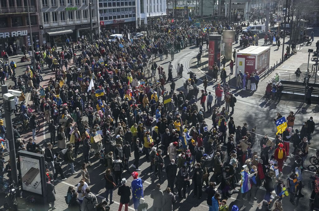Tens of thousands demonstrate in Cologne, Germany, during a peace march against the war in Ukraine on Shrove Monday, Feb. 28, 2022. The traditional carnival Rose Monday Parade in Cologne was cancelled due to Russia's war in Ukraine. Instead of the parade, the political carnival floats were placed in the city followed by a peace protest of revelers. (AP Photo/Martin Meissner)