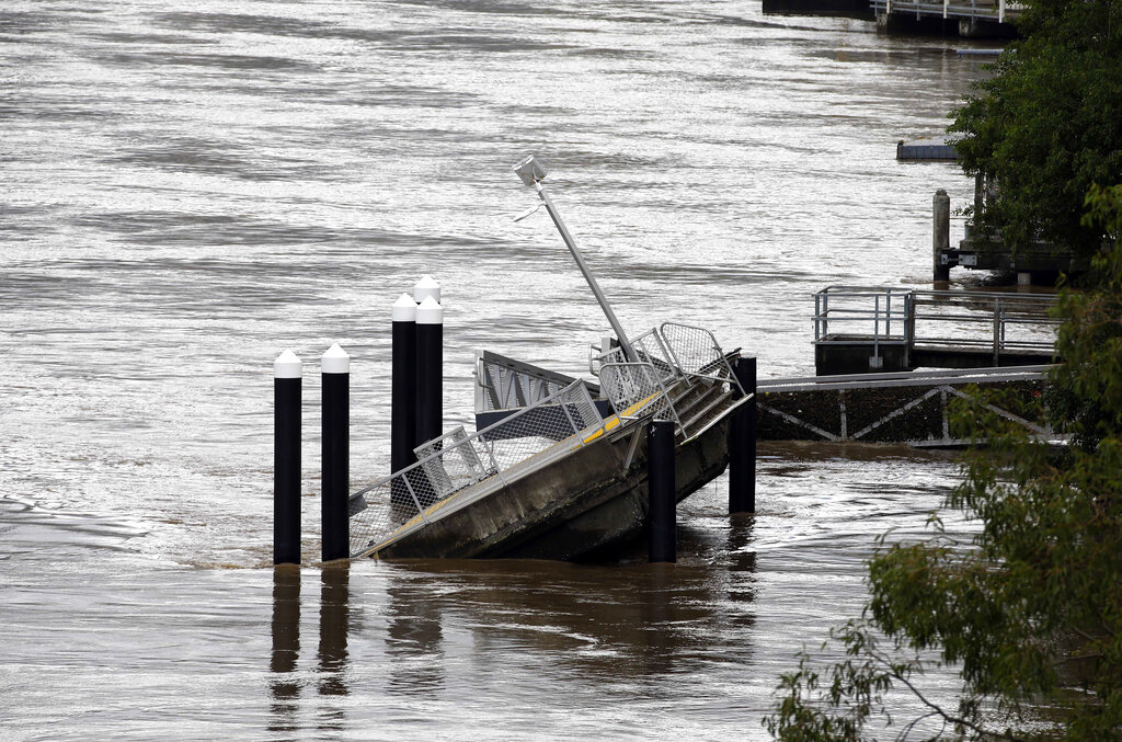 A pontoon is damaged along a river in Brisbane, Australia, Wednesday, March 2, 2022. Tens of thousands of people had been ordered to evacuate their homes and many more had been told to prepare to flee as parts of Australia's southeast coast are inundated by the worst flooding in decades. (AP Photo/Tertius Pickard)