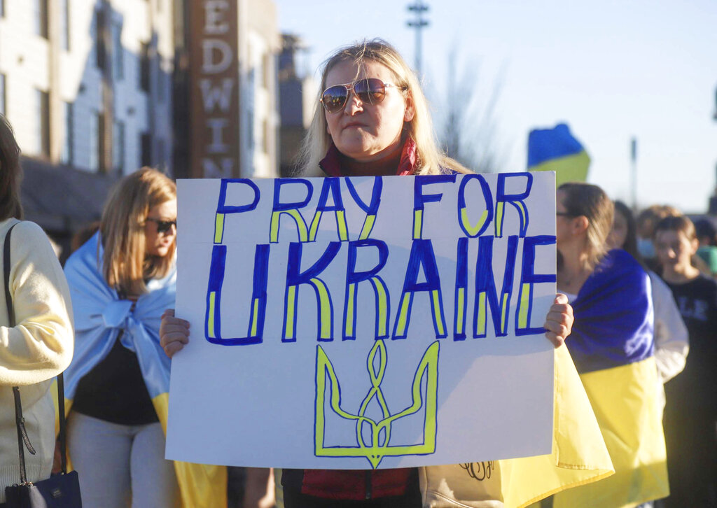 Supporters of Ukraine march across the Walnut Street Bridge, in Chattanooga, Tenn., on Monday, March 1, 2022. The Ukrainian Gospel Church of Chattanooga organized a march and prayer in support of Ukraine. (Olivia Ross /Chattanooga Times Free Press via AP)