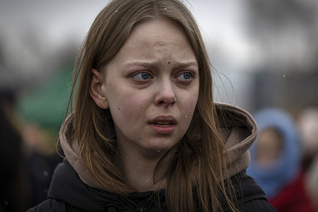 A refugee cries shortly after crossing at the Medyka border crossing in Poland on Saturday March 5, 2022. The number of Ukrainians forced from their country since the Russian invasion has been increasing on a daily basis. (AP Photo/Marc Sanye)
