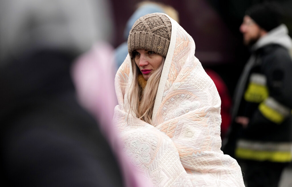 A woman is wrapped in a blanket as she arrives at a humanitarian aid center, for displaced persons fleeing Ukraine, in Przemysl, Poland, Tuesday, March 8, 2022. U.N. officials said Tuesday that the Russian onslaught has forced more than 2 million people to flee Ukraine. (AP Photo/Czarek Sokolowski)