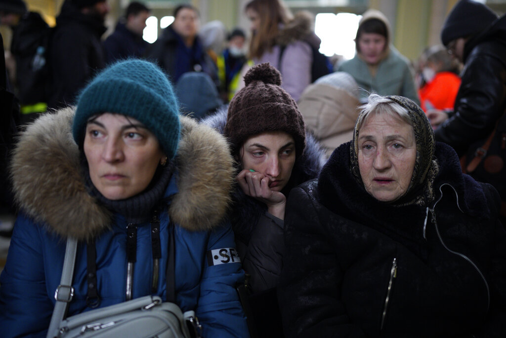 Three generations of women from right, Svetlana, Lisa and Ludmilla, who originally fled from Odessa, Ukraine, arrive at the train station in Przemysl, Poland, after crossing the border in Kroscienko, Poland, Tuesday, March 8, 2022. U.N. officials said Tuesday that the Russian onslaught has forced 2 million people to flee Ukraine. (AP Photo/Daniel Cole)
